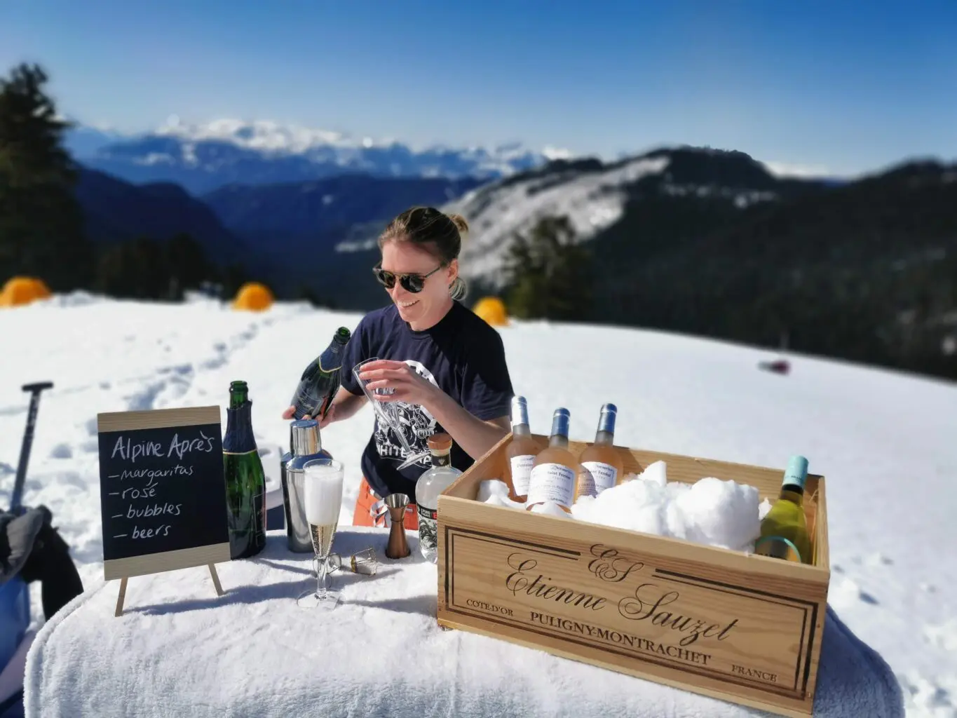 Snow bar - Nickie Mabey preparing drinks for guests after ski touring near Whistler Canada