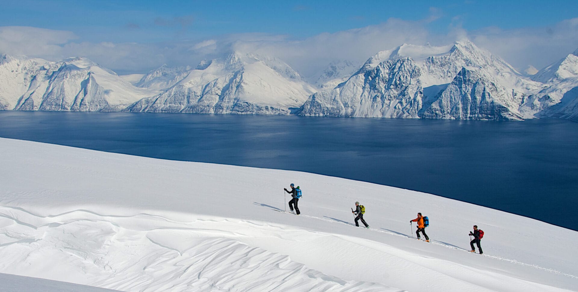 4 skiers ascending Lyngen Alps in Norway