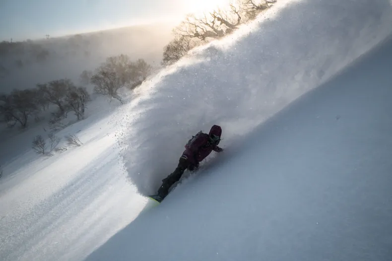 snowboarder carving in powder snow